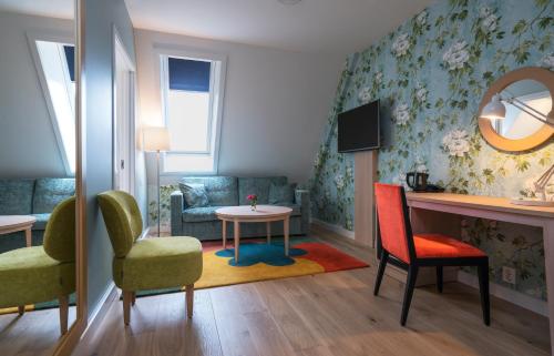 a living room with a couch and chairs and a table at Thon Hotel Tønsberg Brygge in Tønsberg