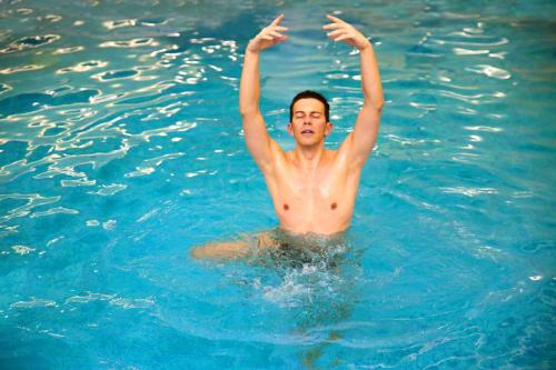 a man in the water with his arms in the water at Hotel La Residence & Idrokinesis in Abano Terme