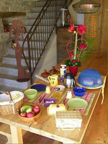 a table with bowls and plates of food on it at Che'Val d'Amour in Écleux