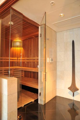 a sauna with a glass door in a room at Arabella Hotel, Golf and Spa in Kleinmond
