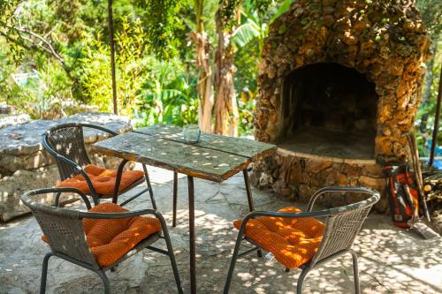 a table and two chairs and a stone oven at Relax tiny villas 40 meters of the beach in Korčula