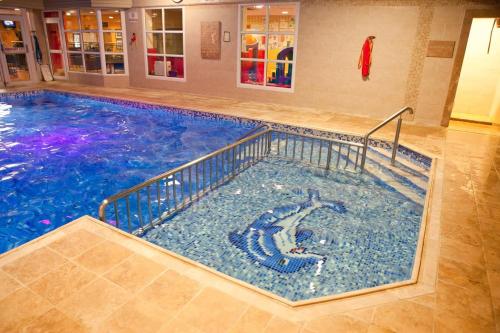 a large swimming pool in a building at Four Seasons Hotel & Leisure Club in Monaghan