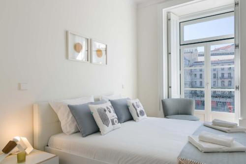 a white bedroom with a bed and a window at TravelingToLisbon 314 - Restauradores in Lisbon