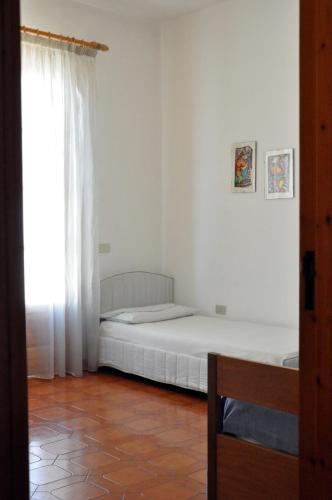 a bedroom with two beds and a window at Due Passi Dalla Spiaggia in Lido Marini