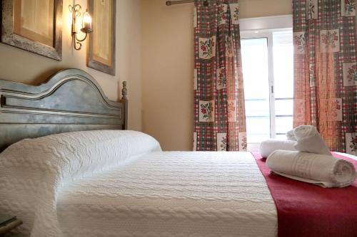 Postel nebo postele na pokoji v ubytování Hostal Victoria