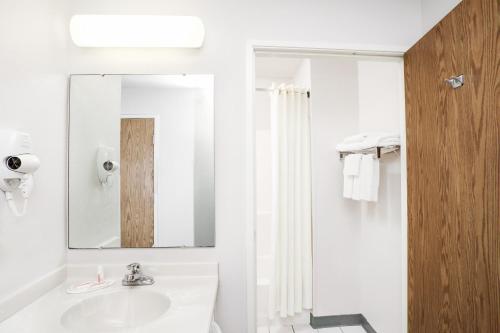 a bathroom with a sink and a mirror at Super 8 by Wyndham Gas City Marion Area in Gas City