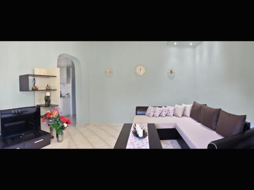 a living room with a couch and a table at Villa Elia in Skala Sotiros