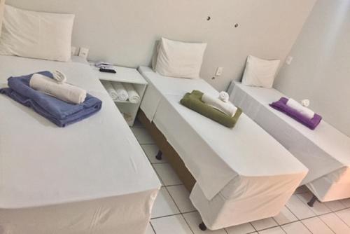 two beds with pillows on them in a room at Acapu Hotel in Rio Verde