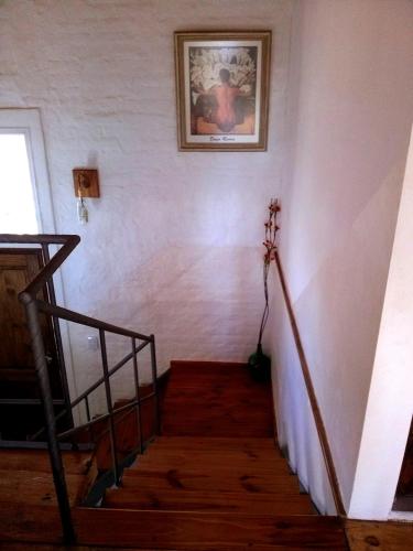 a staircase in a house with a picture on the wall at Balcon de Antares in Uspallata