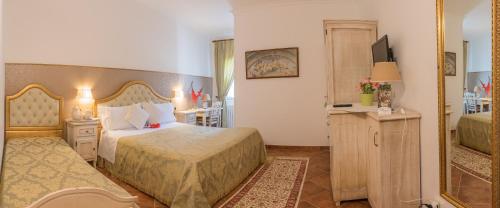 a hotel room with two beds and a television at Agriturismo Salinola in Ostuni