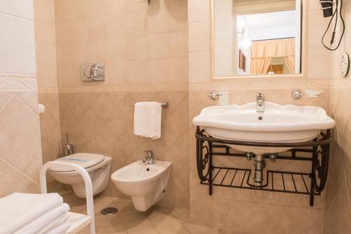 a bathroom with a sink and a toilet at Agriturismo Salinola in Ostuni