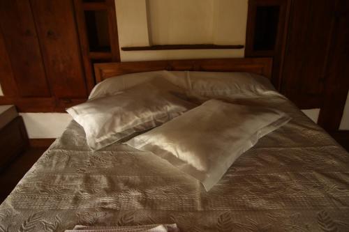 an unmade bed with two pillows on it at Çamlıca Konak Çarsı in Safranbolu