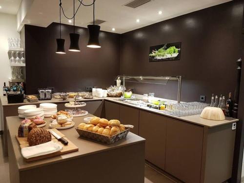 ミュールバッハ・アム・ホーホケーニッヒにあるMarmotta Alpin hotelのカウンターにたくさんの食べ物を並べたキッチン