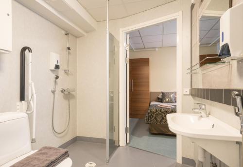 a bathroom with a shower and a toilet and a sink at Gasthaus Patruuna in Joutseno