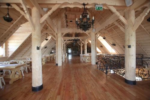 a large room with tables and chairs in a building at Dwór Kresowy in Radymno