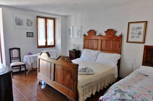 a bedroom with a bed and a dresser in it at La casa di Nonna Nilla in San Giovanni Bianco