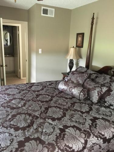a bedroom with a bed with a black and white comforter at The Carriage House of Canton in Canton