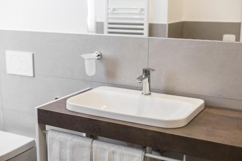 a bathroom with a white sink and a mirror at Hotel Europa in Garda