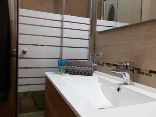 a bathroom with a white sink and a mirror at Affittacamere Il FIORE in Posada