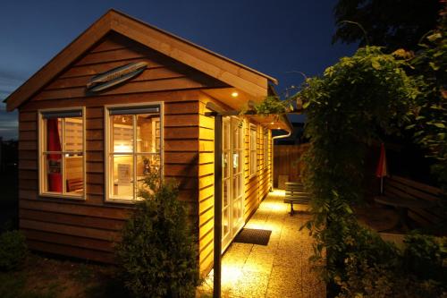 a small cabin with a window on the side of it at The Beach-house nr.98 in Molkwerum