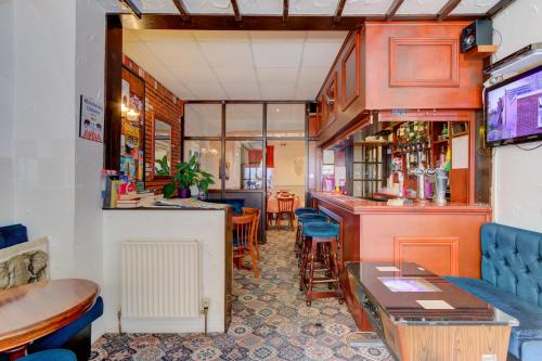 a restaurant with a bar and some tables and chairs at The Strathdon in Blackpool