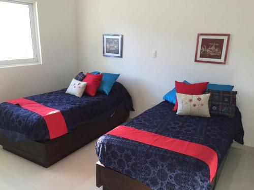 two beds sitting next to each other in a bedroom at Departamento de Lujo en Mazatlan in Mazatlán