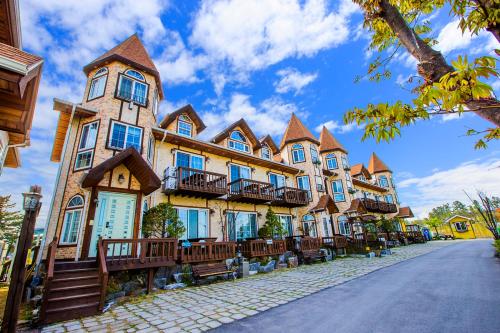 a large building with many windows on a street at Santa Beach Pension in Gangneung