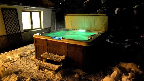 a jacuzzi tub in a house with snow on the ground at Apartamenty Willa Anna in Poronin