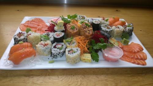 a plate of sushi and vegetables on a table at Shanleys Huon Valley in Glendevie