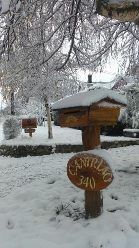 a bird feeder with snow on top of it at Tierras del Sur II in Villa La Angostura