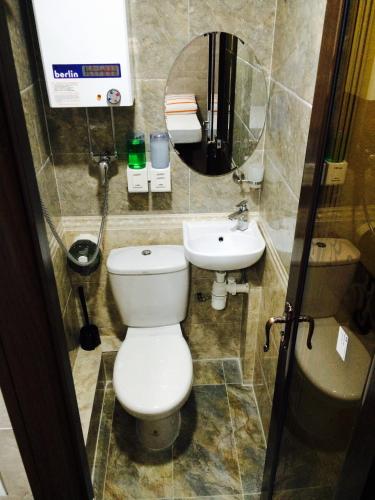 a bathroom with a toilet and a sink at Victoria Inn in Hong Kong