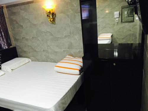 a small room with two beds in a room at Victoria Inn in Hong Kong