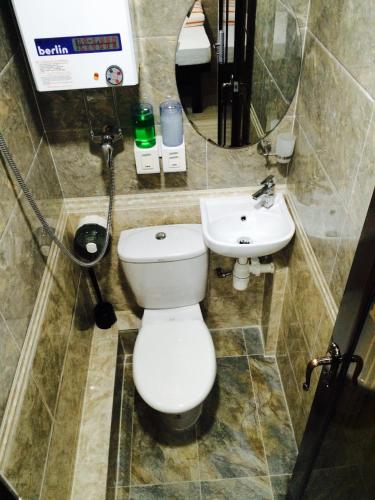 a bathroom with a toilet and a sink at Victoria Inn in Hong Kong