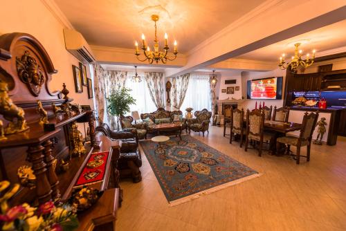 a living room filled with furniture and a dining room at Casa Andrei in Orşova