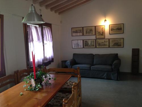 a living room with a table and a couch at Il Giardino Segreto in Rho