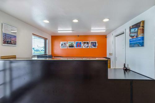 a ping pong table in a room with an orange wall at Motel 6-San Marcos, TX - North in San Marcos