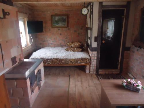 a small room with a bed in a brick wall at Namelis in Einoriai