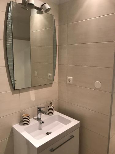 a bathroom with a sink and a mirror at Apartment Kiara in Omišalj