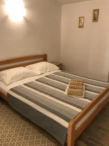 a large bed in a bedroom with at Apartment Kiara in Omišalj