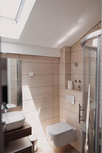 a bathroom with a toilet and a sink at The Nikolic Suites - Villa Wögenstein in Tribunj
