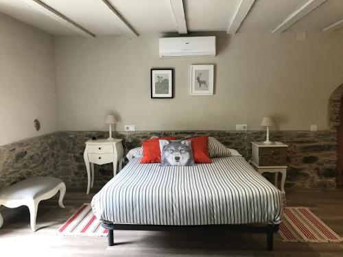 a bedroom with a bed with a dog pillow on it at Hostal Sant Roc in Montseny