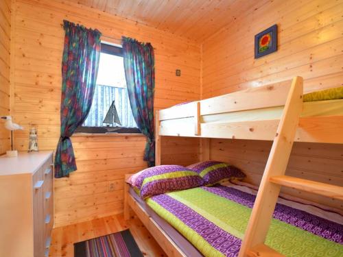 a bedroom with a bunk bed in a log cabin at Morskie Zacisze in Gąski