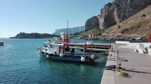 a boat is docked at a dock in the water at Residenza Wagner in Palermo