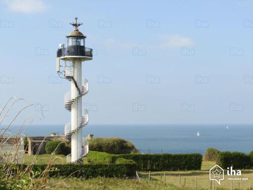 a lighthouse on a hill near the ocean at STUDIO 100 m PLAGE in Le Portel