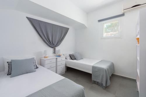 Postel nebo postele na pokoji v ubytování Vamare Beachfront House