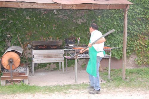 a man standing in front of a grill at Hotel Terme Orvieto in Abano Terme