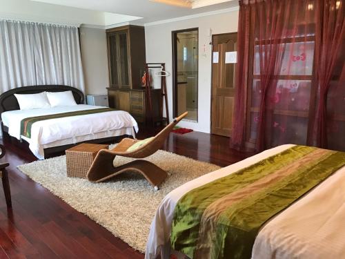 a bedroom with two beds and a pair of shoes on a rug at Emaly Homestay in Taitung City