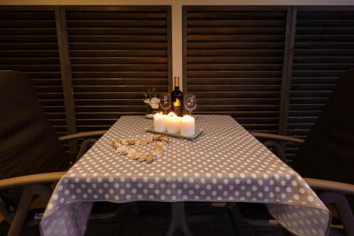 a table with candles and wine bottles on it at Mobile Homes - FKK Nudist Camping Solaris in Poreč