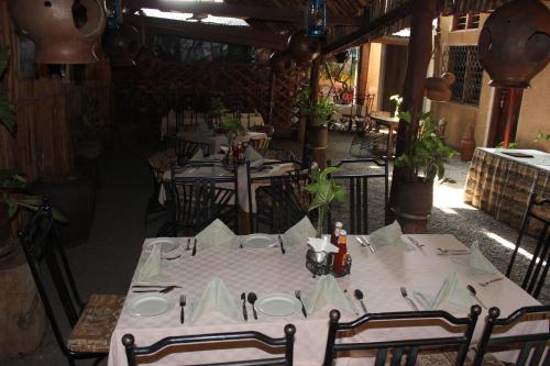 a dining room with tables and chairs in a restaurant at Kindoroko Hotel in Moshi