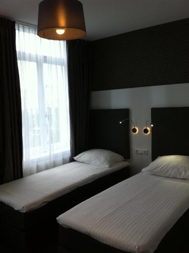 Cama o camas de una habitación en Hotel Vossius Vondelpark